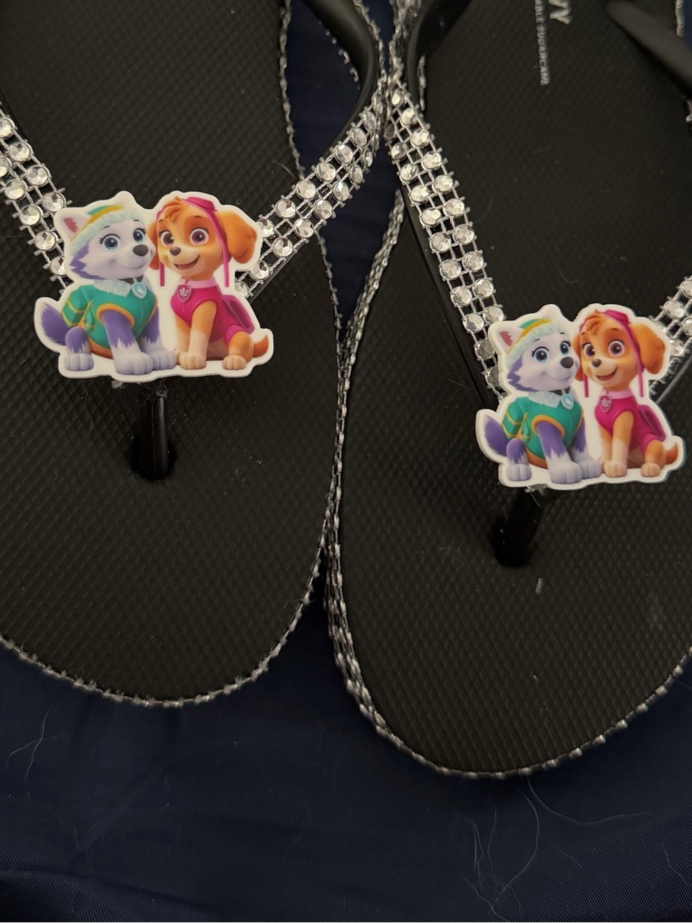 Black Flip Flops with Colorful Paw Patrol Character Accents